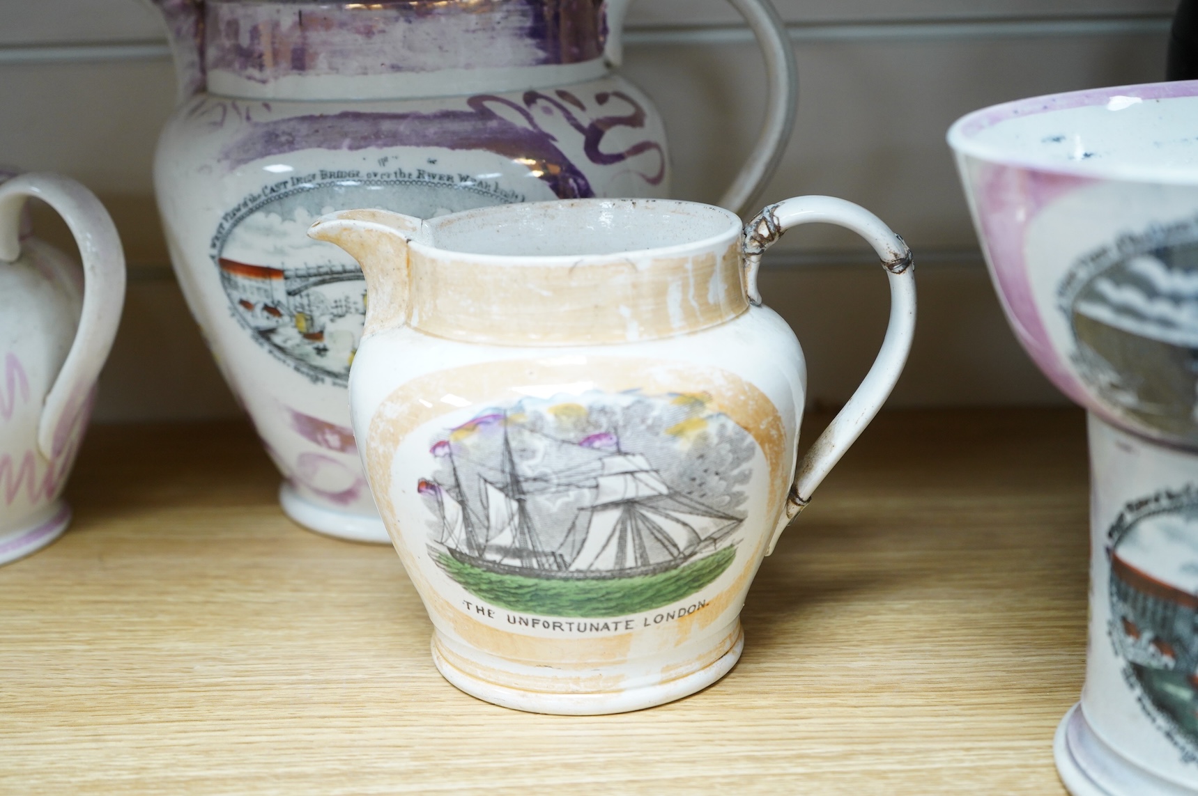 Six early 19th century commemorative jugs and bowls, three with transfer printed scenes of the cast iron bridge over the River Wear commemorating the opening in 1796, together with three others with naval themes, largest